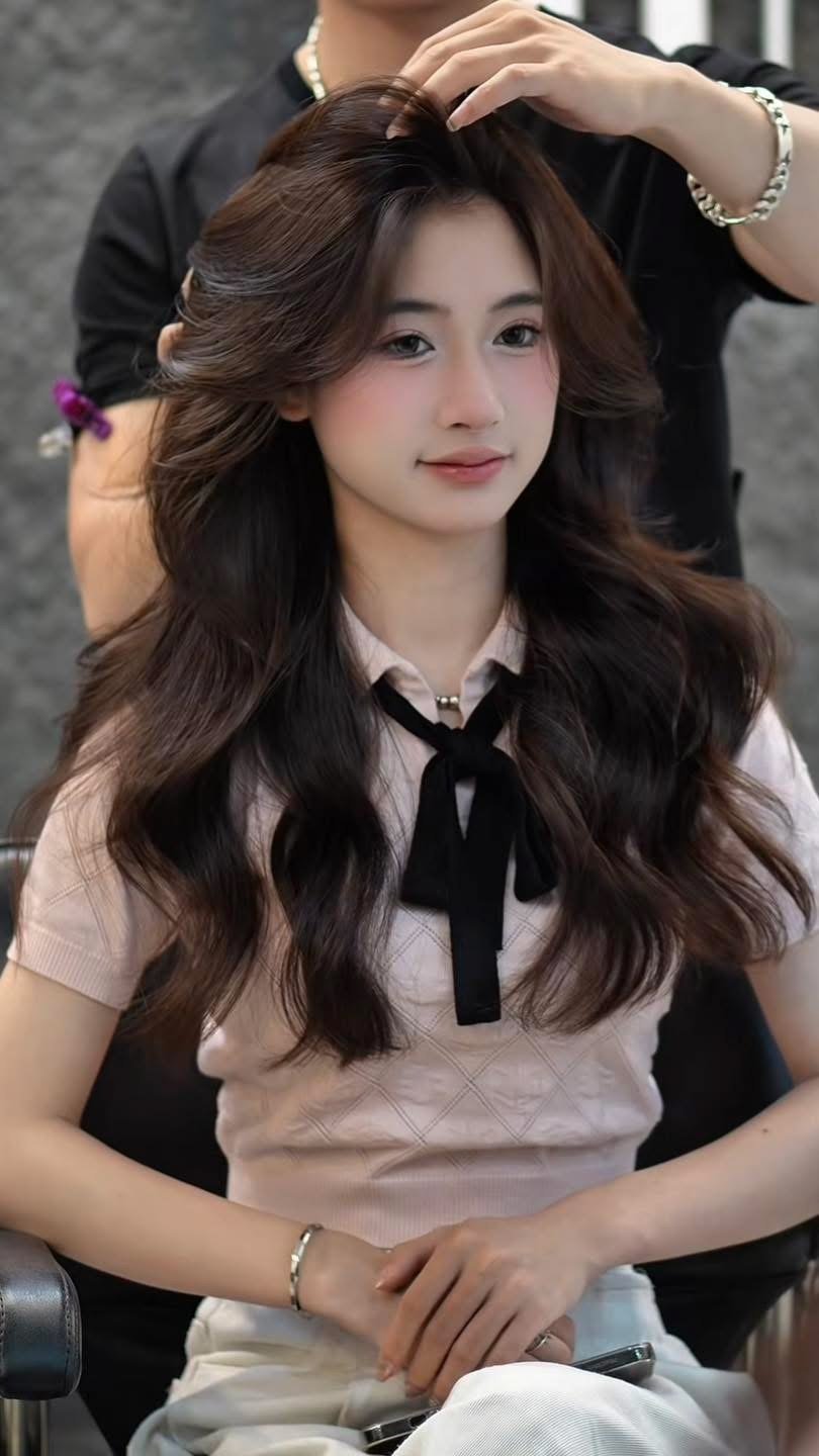 Warm milk tea brown on long soft waves, a Korean tone that sits close to the natural level of Asian hair