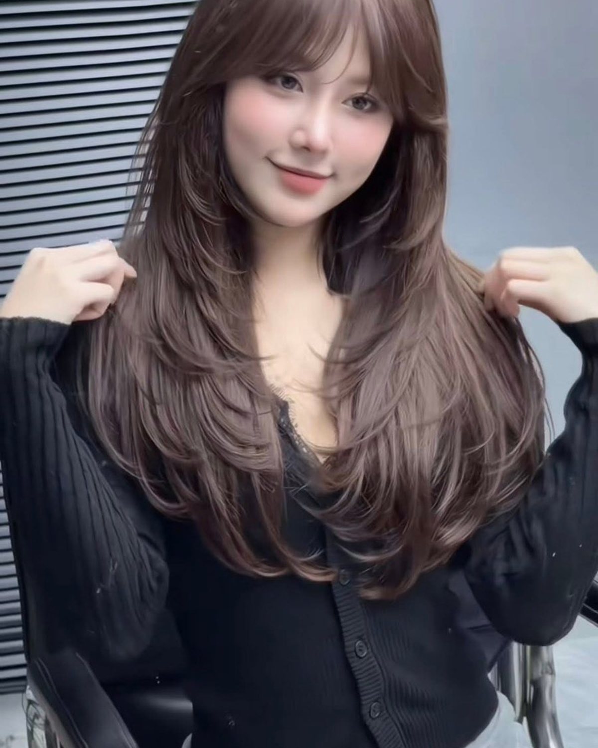 Brown layered hair with curled ends styled at Nhat Tam Hair Salon in Hanoi