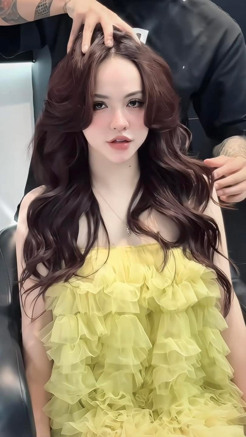 Dark red brown hair in large loose curls after a colour and perm session