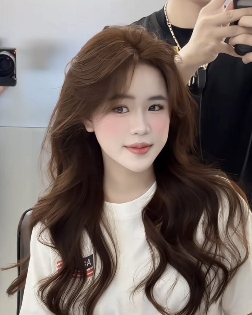 Long chocolate brown hair with soft waves finished at Nhat Tam Hair Salon in Hanoi