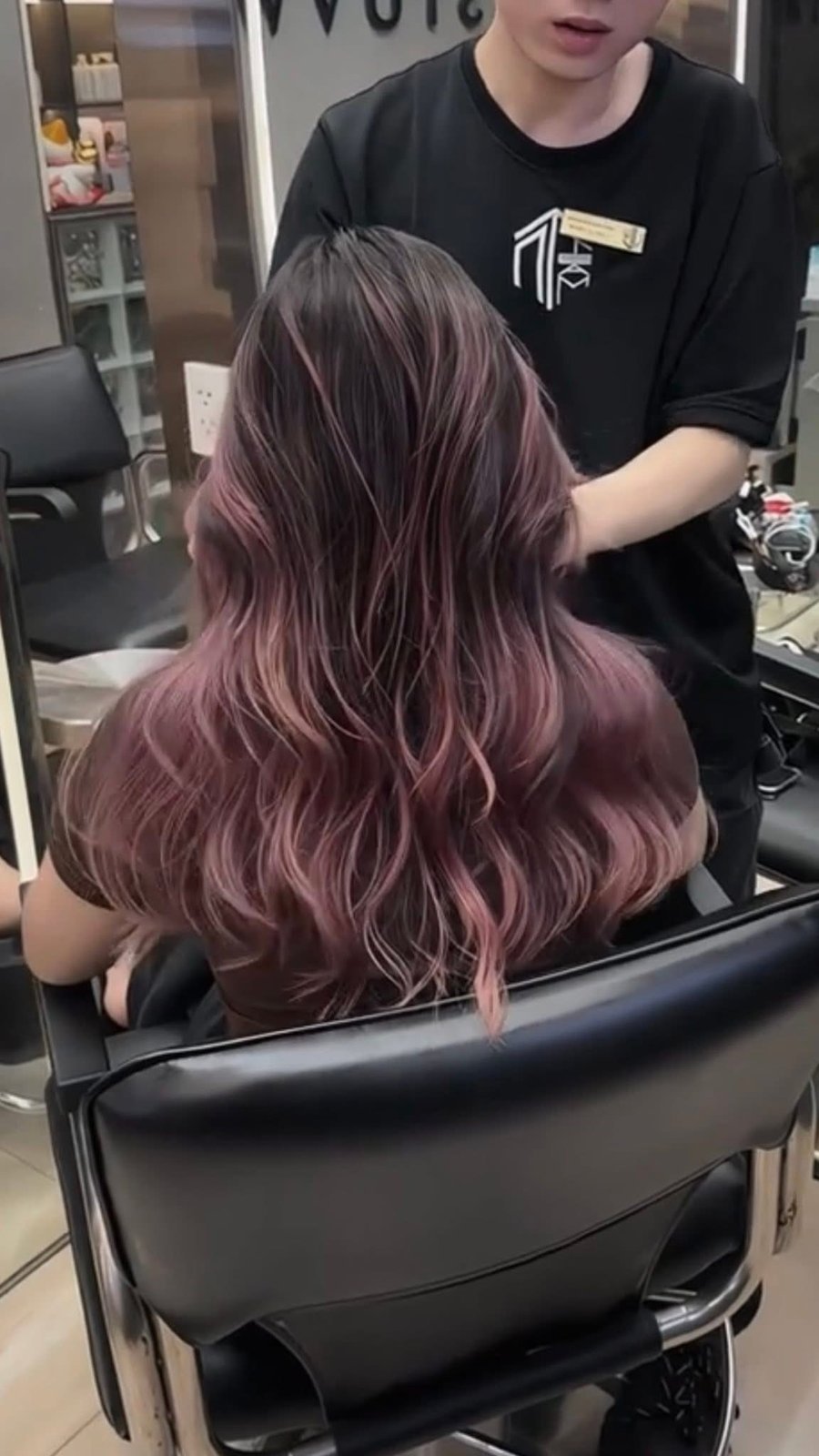 Mauve rose-brown fashion hair colour on long wavy hair in the salon chair at Nhat Tam Hanoi