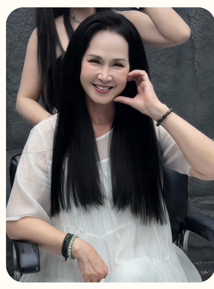 People’s Artist Lan Huong having her long straight black hair finished by a stylist at Nhat Tam Hair Salon in Hanoi