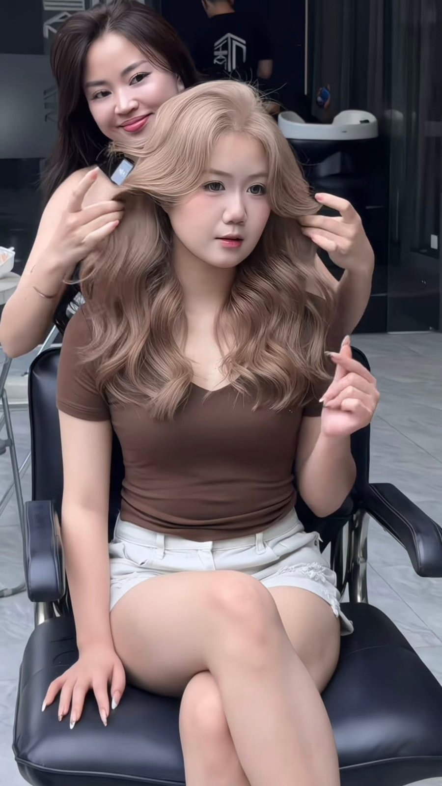 Stylist finishing a beige blonde blow dry at Nhat Tam Hair Salon in Hanoi