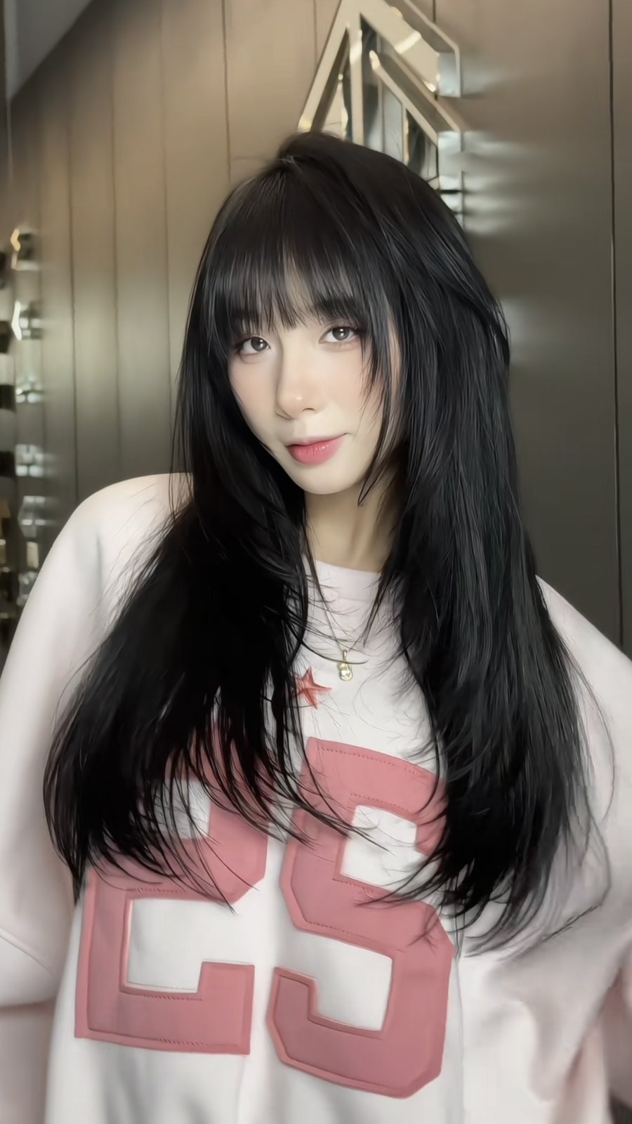 Waist-length black hair with a full eyebrow-length fringe and face-framing sections cut at Nhat Tam Hair Salon in Hanoi